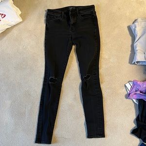 Black skinny jeans with rips in the knees